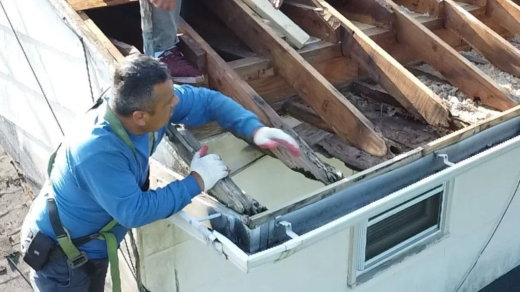 Contractor working along the edge of a residential roof